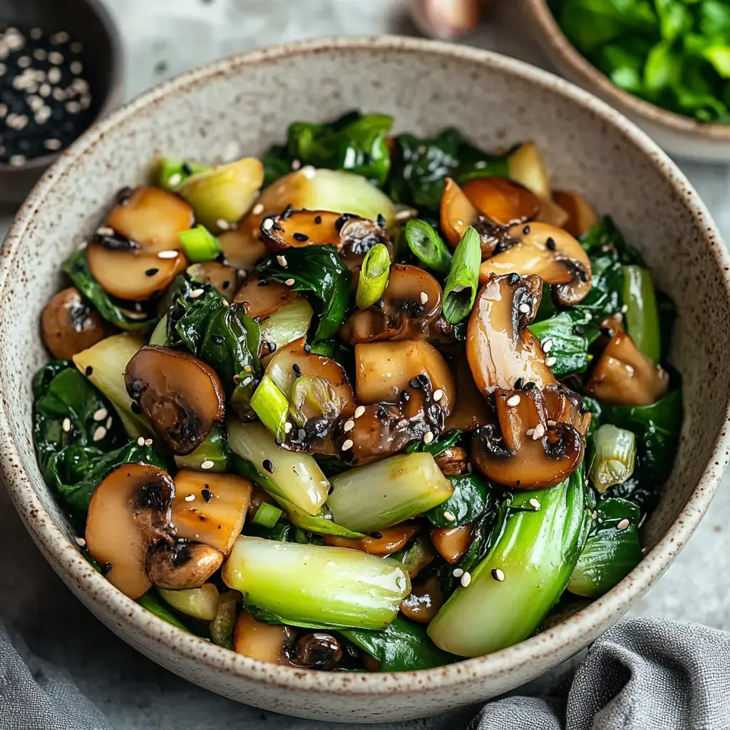 A serving of stir-fried vegetables and mushrooms with green onions and sesame seeds.